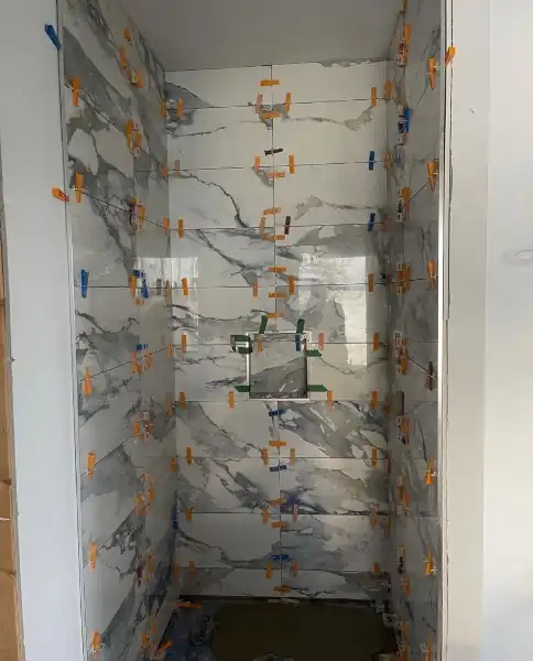 Marble tile shower stall, floor to ceiling