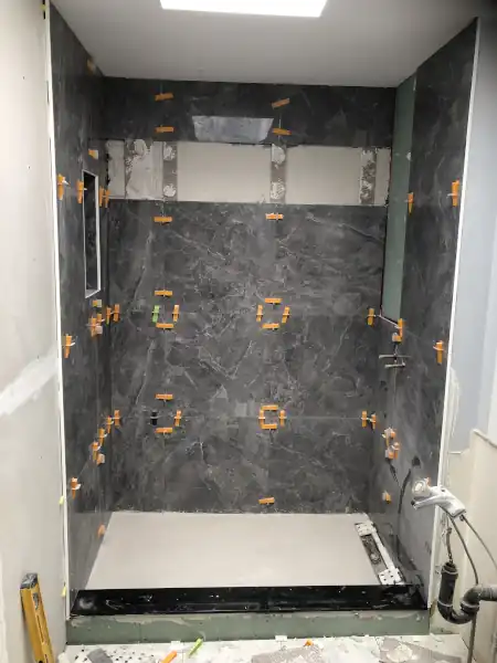 Grey marble tile shower niche, installation in progress