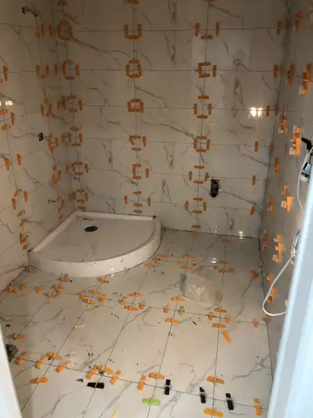 Shower floor tile installation in progress