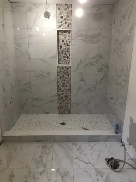 Marble-look large-format tile bathroom floor installation